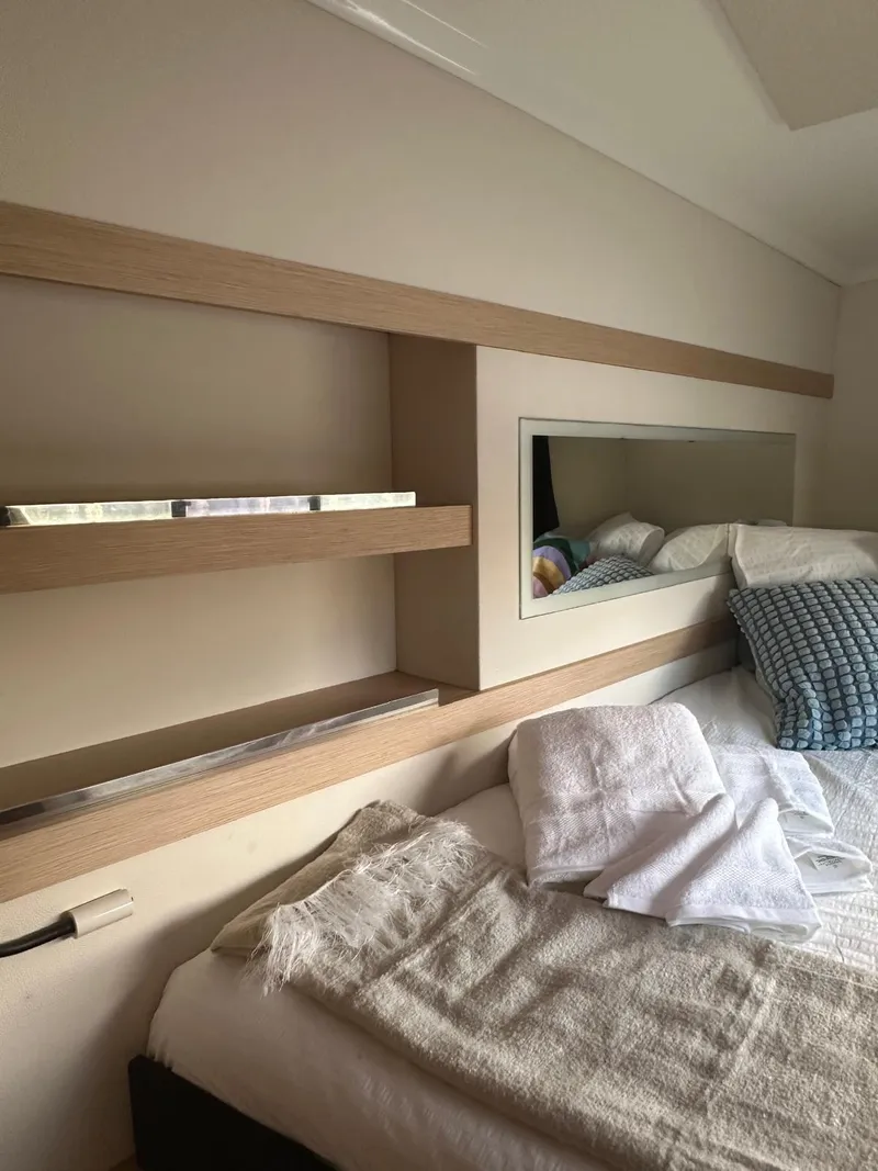 Slide: The Image of Cozy cabin interior of 2019 Fountaine Pajot Lucia 40 catamaran with bed and shelves. - 33