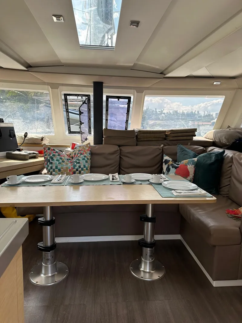 Slide: The Image of Interior of 2019 Fountaine Pajot Lucia 40 catamaran with dining area and plush seating. - 7