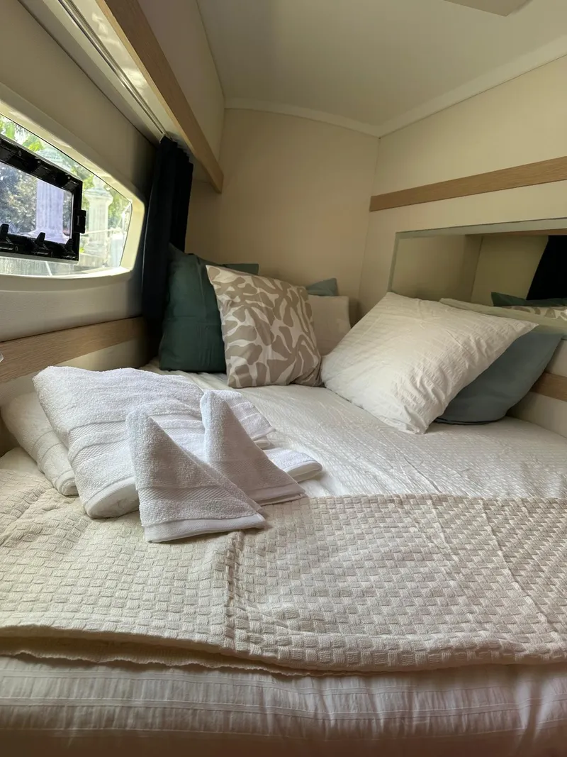 Slide: The Image of Cozy cabin interior of 2019 Fountaine Pajot Lucia 40 with neatly arranged bedding. - 9