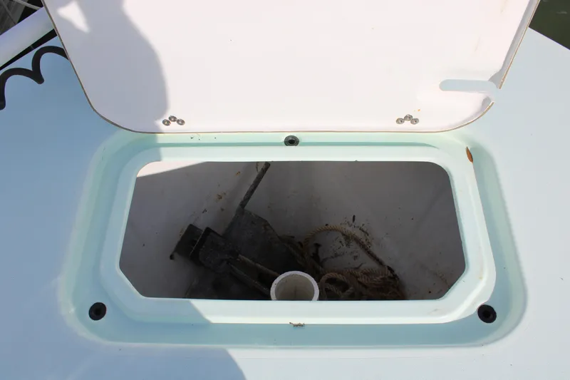 Slide: The Image of Open storage compartment on 2021 ZCB 26 Freemason boat, containing anchor and rope. - 15