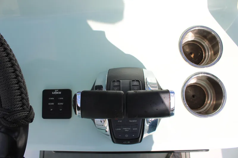 Slide: The Image of Boat throttle controls and cup holders on 2021 ZCB 26 Freemason. - 19