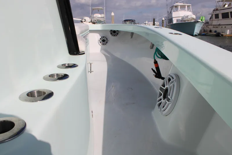 Slide: The Image of ZCB 26 Freemason 2021 boat interior with rod holders and speakers in a marina. - 21