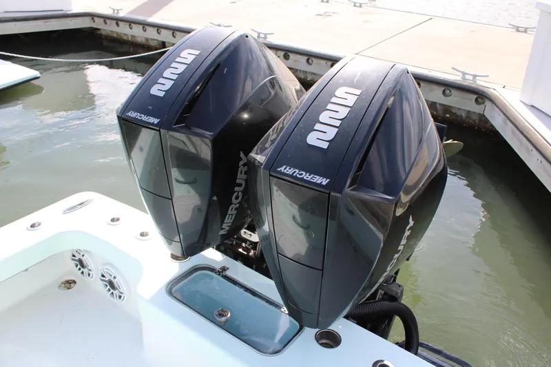 Slide: The Image of Twin Mercury outboard engines on a 2021 ZCB 26 Freemason boat at dock. - 23