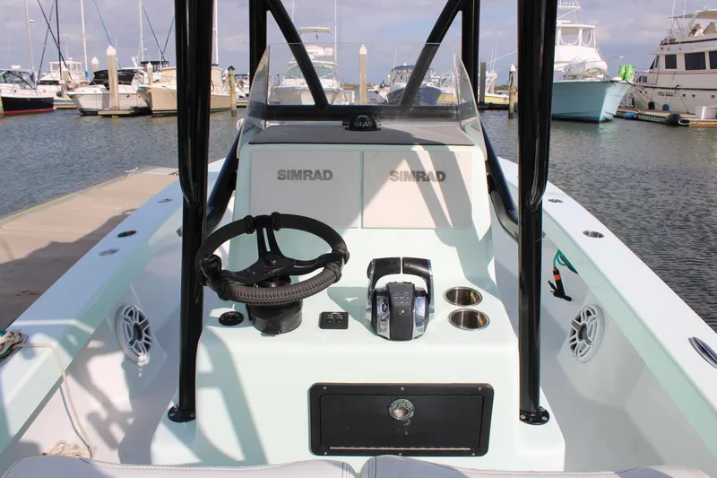 Slide: The Image of 2021 ZCB 26 Freemason boat console with steering wheel and controls at marina. - 25
