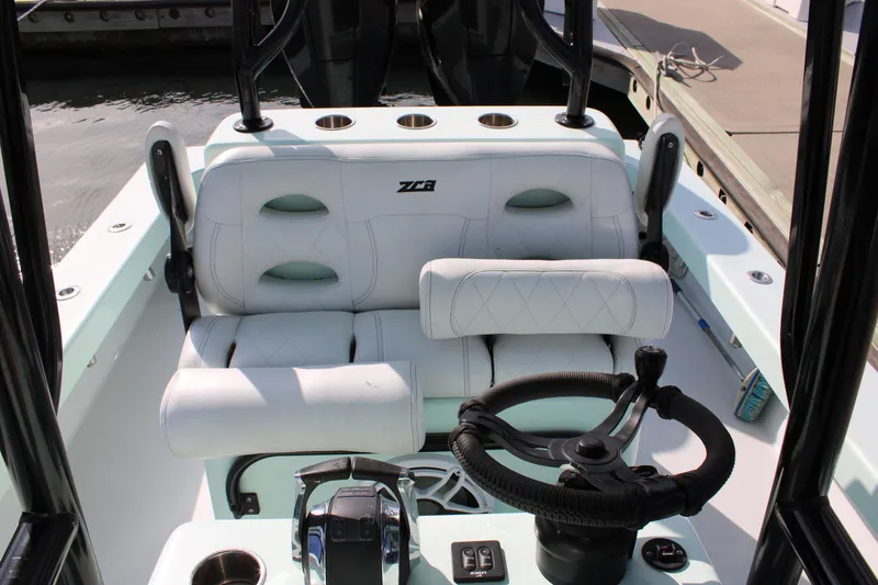 Slide: The Image of 2021 ZCB 26 Freemason boat interior with steering wheel and seating. - 26