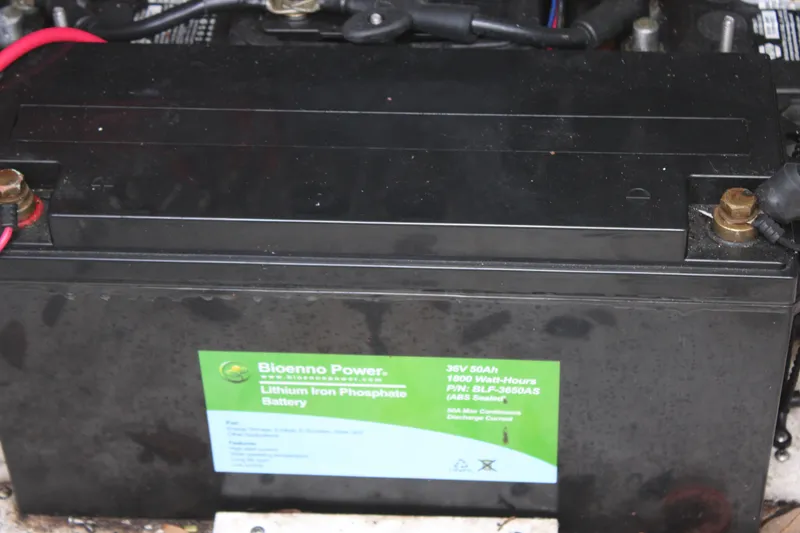 Slide: The Image of ZCB 26 Freemason 2021 lithium iron phosphate battery with label and red cable connection. - 27