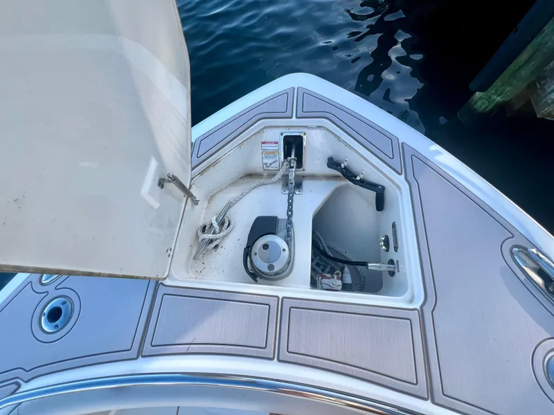 Slide: The Image of Boston Whaler 350 Realm 2018 anchor compartment, open lid, dockside view. - 6