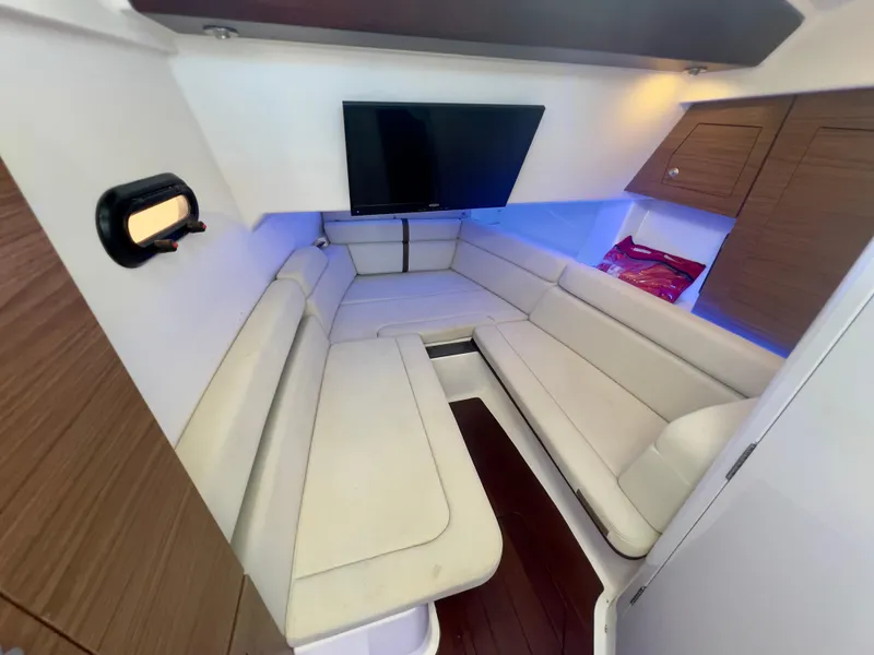 Slide: The Image of Luxurious interior of 2018 Boston Whaler 350 Realm with plush seating and modern TV. - 8
