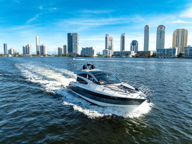 Slide: The Image of Galeon 430 HTC yacht cruising near city skyline, 2016 model. - 10