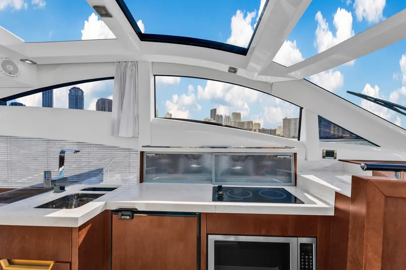 Slide: The Image of Interior of 2016 Galeon 430 HTC yacht with modern kitchen and city skyline view. - 20