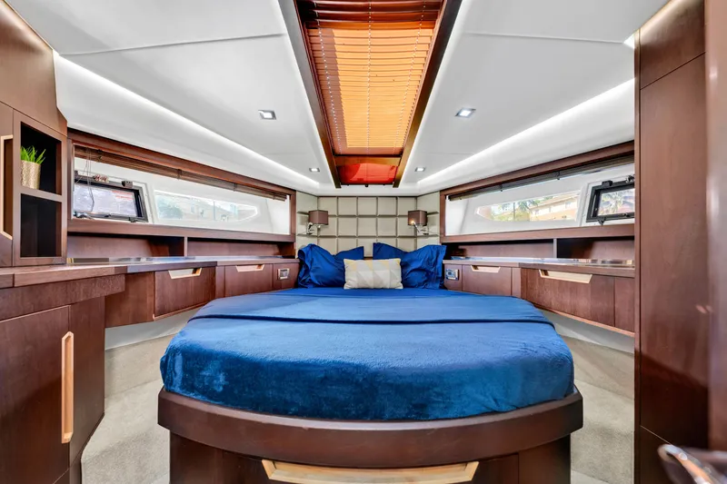 Slide: The Image of Luxurious interior of 2016 Galeon 430 HTC yacht with elegant wood finishes and plush bedding. - 22