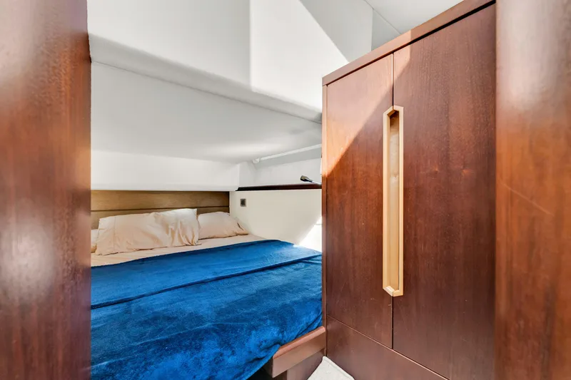 Slide: The Image of Cozy bedroom interior of 2016 Galeon 430 HTC yacht with blue bedding. - 31
