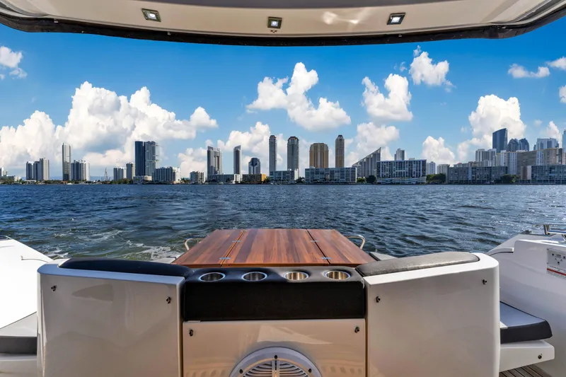 Slide: The Image of Galeon 430 HTC 2016 yacht with city skyline view, open deck, and blue sky. - 44