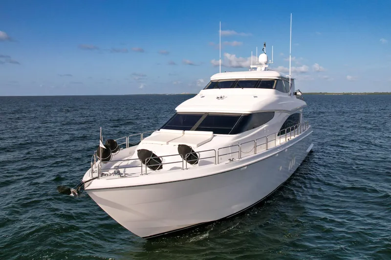 Slide: The Image of 2007 Hatteras 80 Motor Yacht cruising on open water under clear skies. - 12
