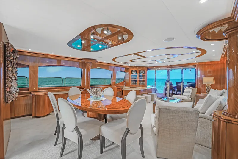 Slide: The Image of Luxurious interior of 2007 Hatteras 80 Motor Yacht with elegant dining and seating area. - 23