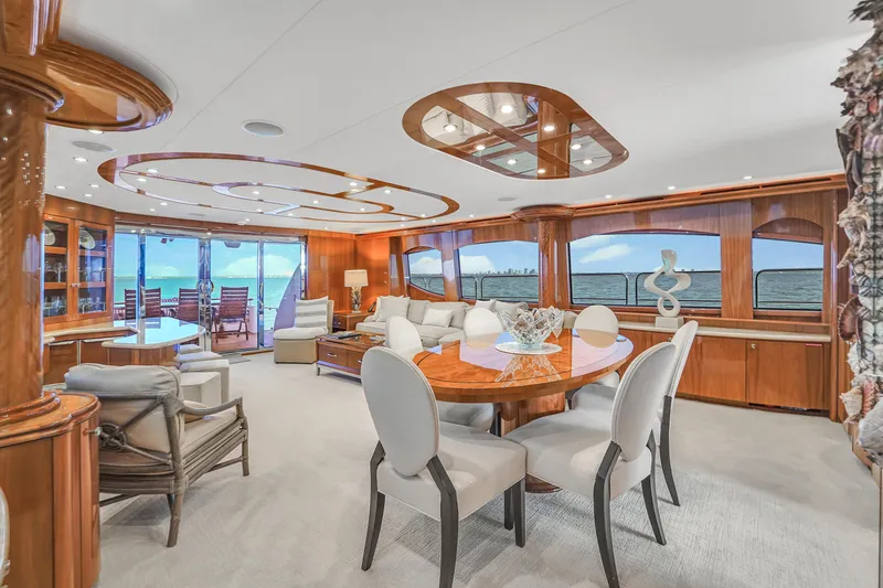 Slide: The Image of Luxurious interior of 2007 Hatteras 80 Motor Yacht with elegant dining area and ocean views. - 24