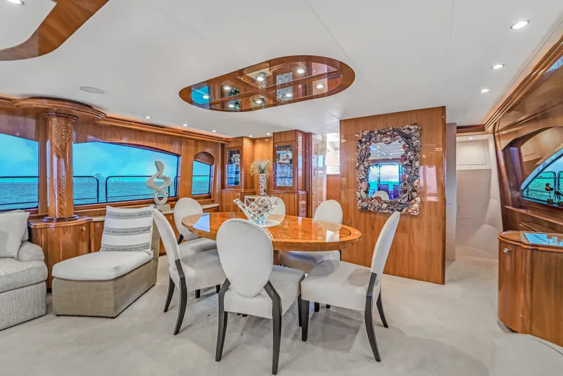 Slide: The Image of Luxurious interior of 2007 Hatteras 80 Motor Yacht with elegant dining area and ocean views. - 27