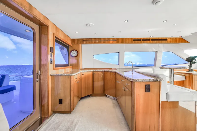 Slide: The Image of Luxurious interior of 2007 Hatteras 80 Motor Yacht with wood cabinetry and ocean view. - 30