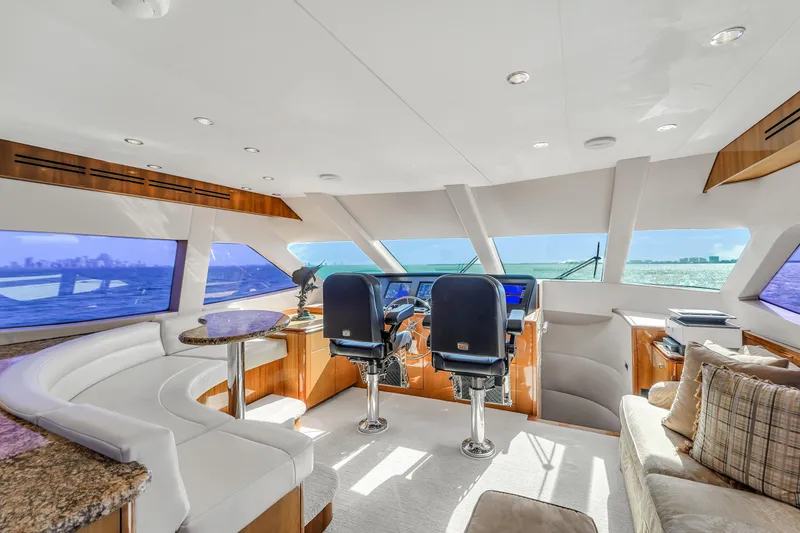 Slide: The Image of Luxurious interior of 2007 Hatteras 80 Motor Yacht with panoramic windows and plush seating. - 31