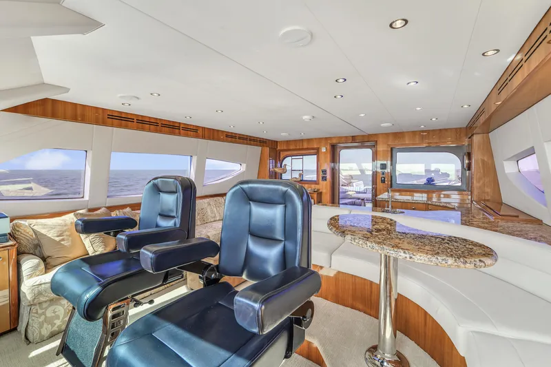 Slide: The Image of Luxurious interior of 2007 Hatteras 80 Motor Yacht with plush seating and panoramic windows. - 39