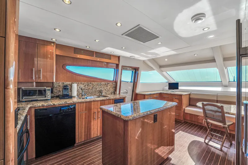 Slide: The Image of Luxurious kitchen interior of 2007 Hatteras 80 Motor Yacht with wood cabinetry and granite countertops. - 42