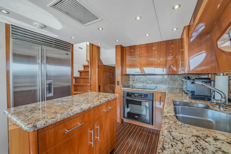 Slide: The Image of Luxurious kitchen in 2007 Hatteras 80 Motor Yacht with granite countertops and stainless steel appliances. - 44