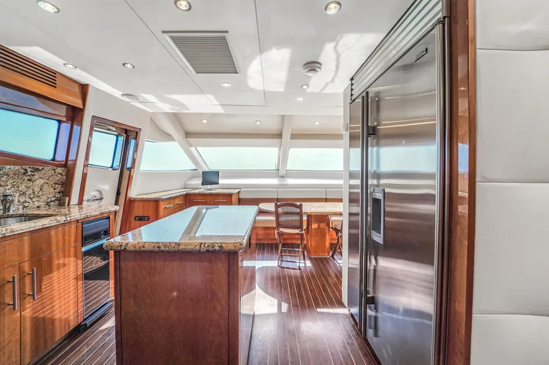 Slide: The Image of Luxurious kitchen interior of 2007 Hatteras 80 Motor Yacht with modern appliances and wood finishes. - 46