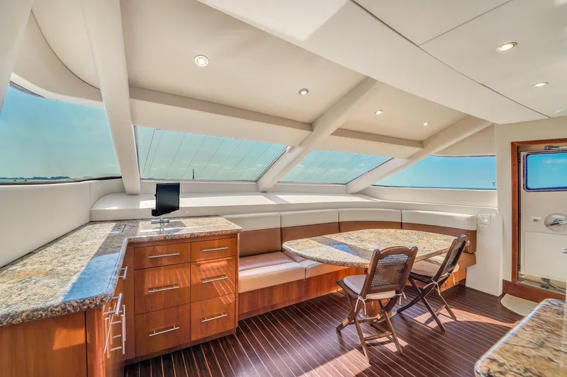 Slide: The Image of Luxurious interior of 2007 Hatteras 80 Motor Yacht with elegant seating and panoramic windows. - 47