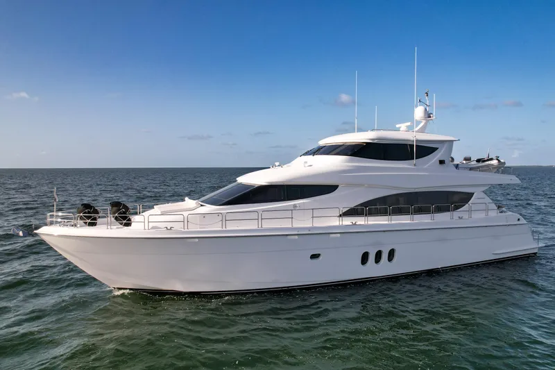 Slide: The Image of 2007 Hatteras 80 Motor Yacht cruising on open water under clear blue sky. - 7