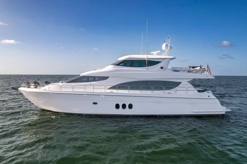 Slide: The Image of 2007 Hatteras 80 Motor Yacht cruising on open water under clear skies. - 8