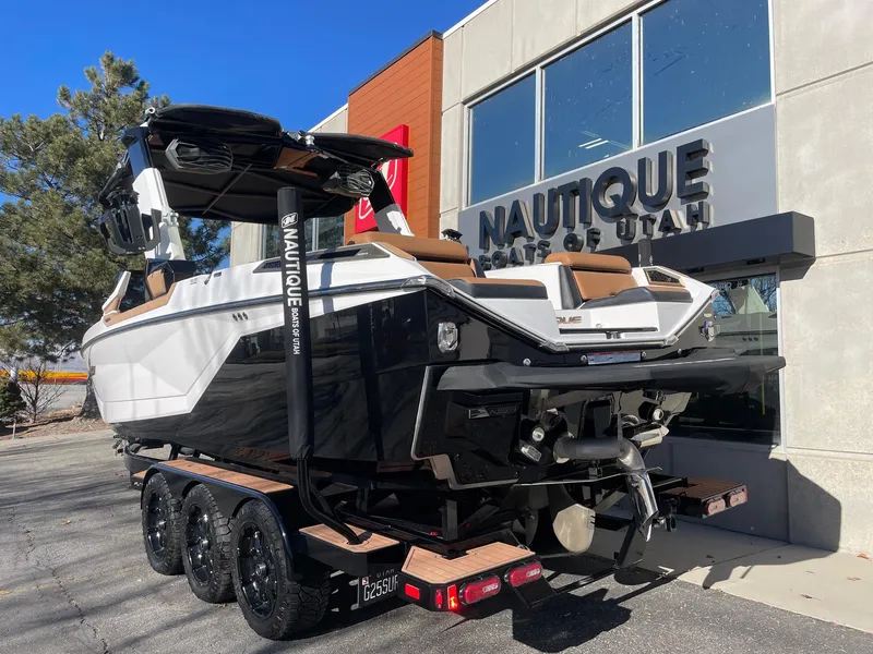 Slide: The Image of 2023 Nautique Super Air Nautique G25 Paragon boat on trailer outside dealership. - 3