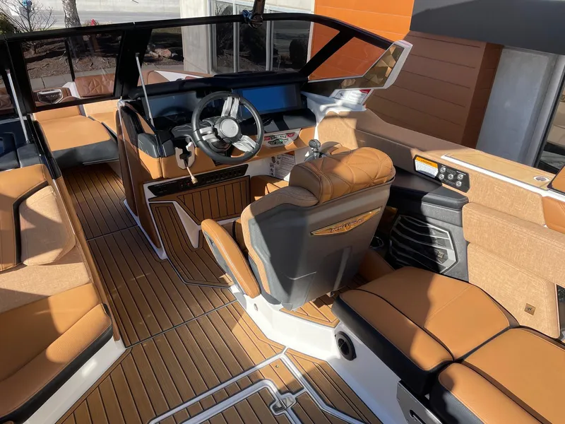 Slide: The Image of 2023 Nautique Super Air Nautique G25 Paragon interior with luxurious seating and modern dashboard. - 6