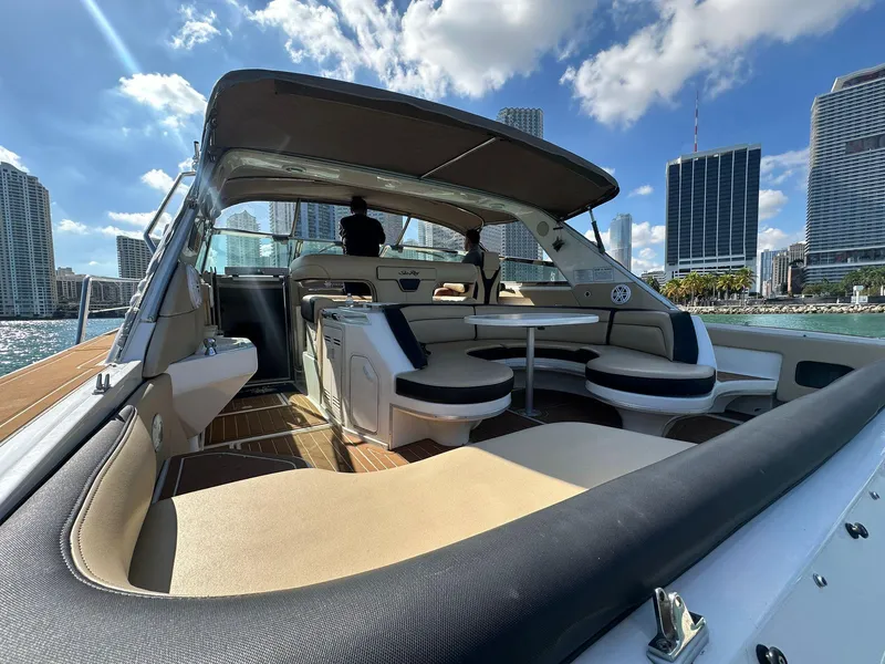 Slide: The Image of 1998 Sea Ray 500 Sundancer yacht with spacious deck and city skyline backdrop. - 10