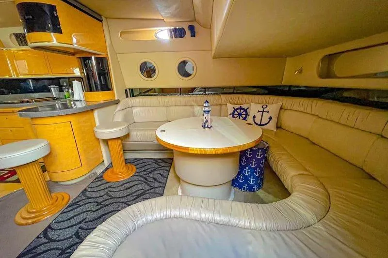 Slide: The Image of Luxurious interior of 1998 Sea Ray 500 Sundancer yacht with cozy seating and nautical decor. - 13