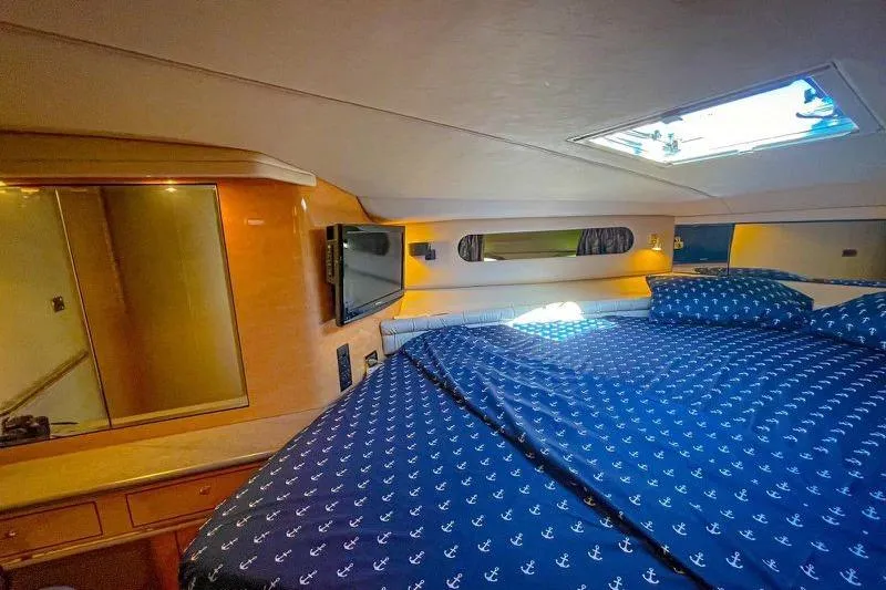 Slide: The Image of Luxurious cabin interior of 1998 Sea Ray 500 Sundancer yacht with nautical bedding. - 14