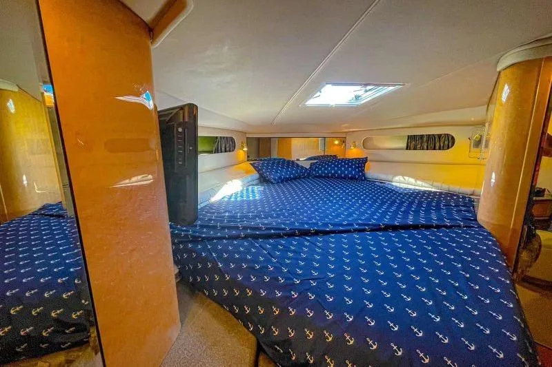 Slide: The Image of Luxurious cabin interior of 1998 Sea Ray 500 Sundancer yacht with cozy bedding. - 15
