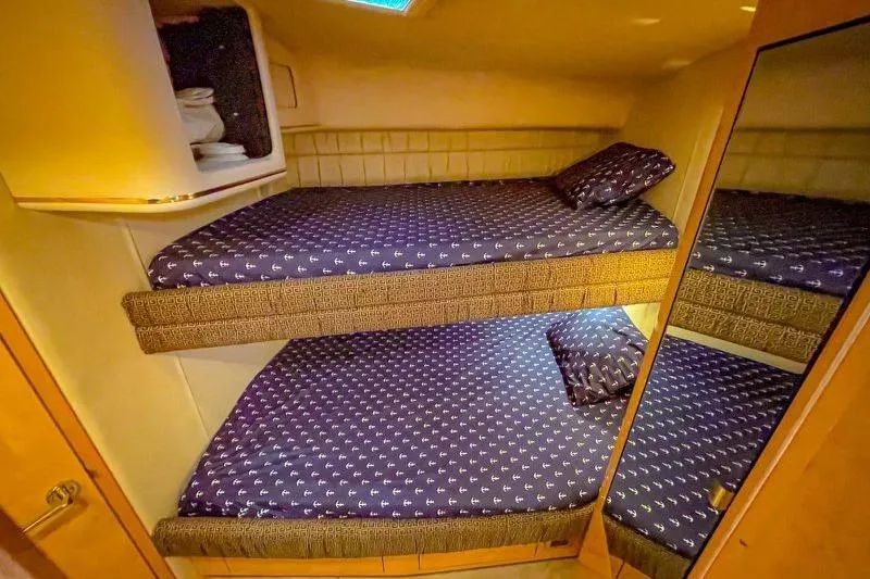Slide: The Image of Bunk beds in 1998 Sea Ray 500 Sundancer yacht cabin with patterned bedding. - 16