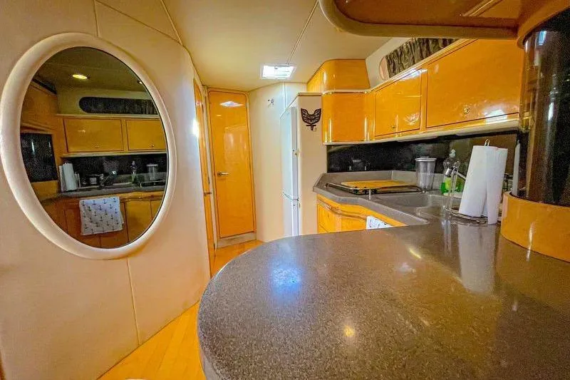 Slide: The Image of Interior of 1998 Sea Ray 500 Sundancer yacht with modern kitchen and sleek design. - 18