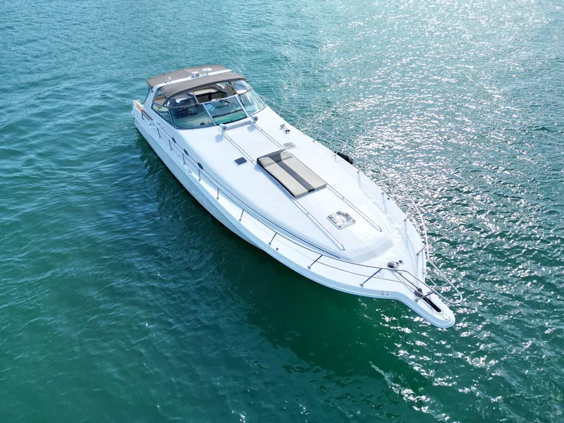 Slide: The Image of 1998 Sea Ray 500 Sundancer yacht cruising on clear blue water. - 24