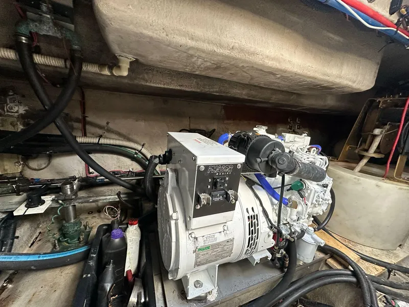 Slide: The Image of Engine room of 1998 Sea Ray 500 Sundancer with visible generator and wiring. - 27