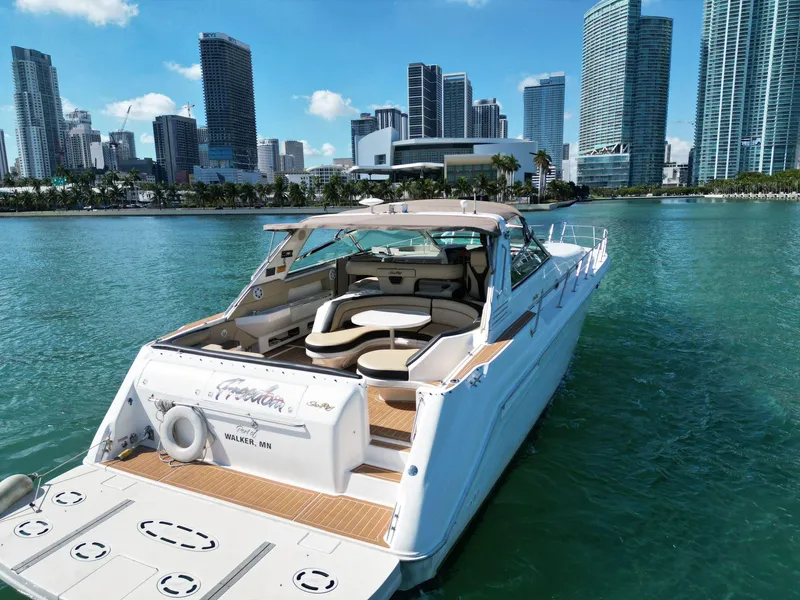 Slide: The Image of 1998 Sea Ray 500 Sundancer yacht on water with city skyline background. - 4