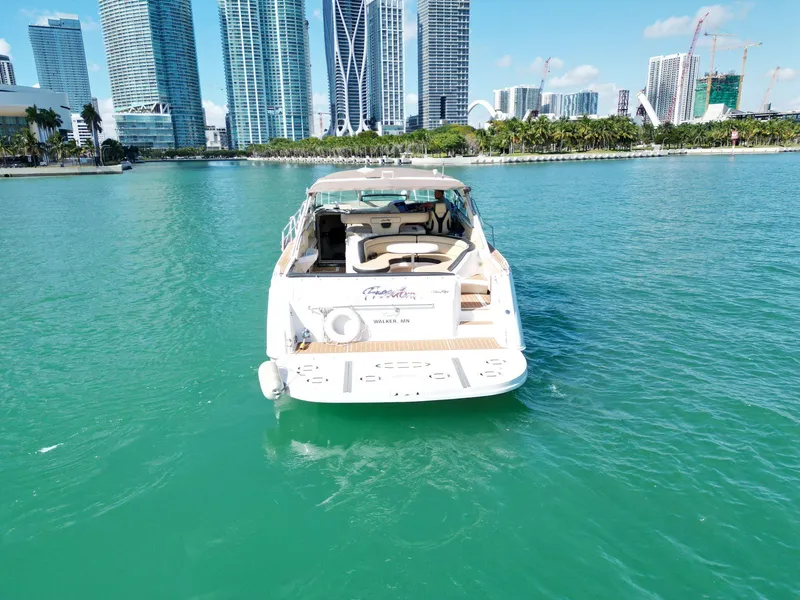 Slide: The Image of 1998 Sea Ray 500 Sundancer yacht on turquoise water with city skyline backdrop. - 6