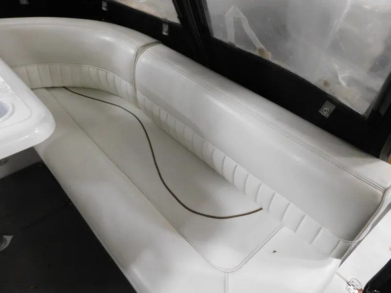 Slide: The Image of White leather seating in 1998 Cruisers 2870 Rogue boat interior. - 10