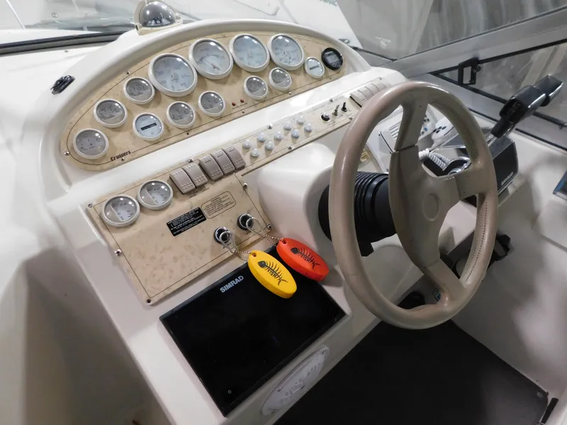Slide: The Image of 1998 Cruisers 2870 Rogue boat dashboard with steering wheel and instrument panel. - 14