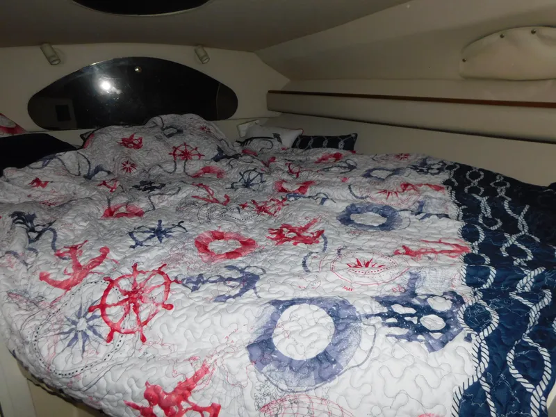 Slide: The Image of Cozy cabin bed in 1998 Cruisers 2870 Rogue with nautical-themed bedding. - 21