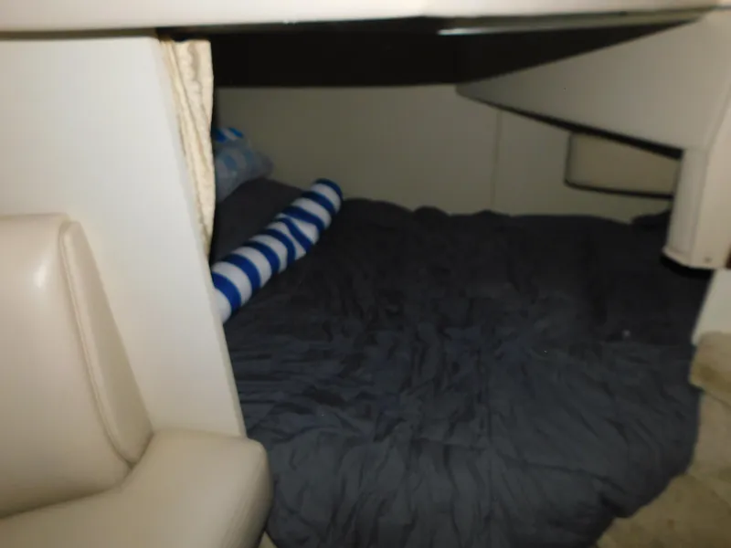Slide: The Image of 1998 Cruisers 2870 Rogue cabin interior with bed and striped pillow. - 24