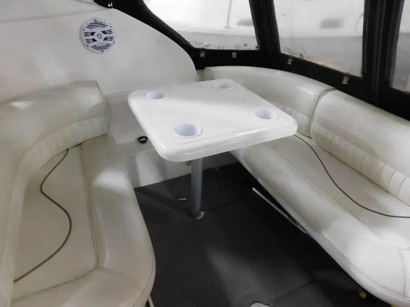 Slide: The Image of 1998 Cruisers 2870 Rogue interior with white seating and table, featuring cup holders. - 9