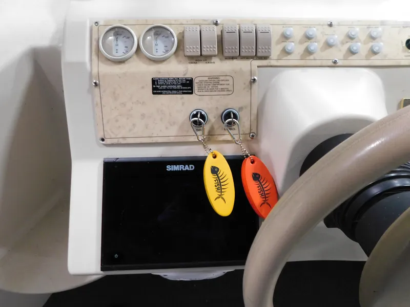 Slide: The Image of Control panel of a 1998 Cruisers 2870 Rogue boat with gauges and key fobs. - 15