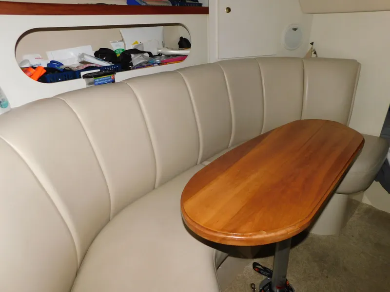 Slide: The Image of 1998 Cruisers 2870 Rogue interior with beige seating and wooden table. - 18