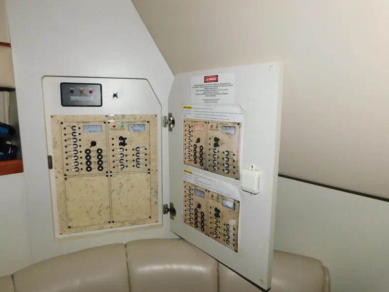 Slide: The Image of Electrical panel inside a 1998 Cruisers 2870 Rogue boat, featuring circuit breakers. - 23